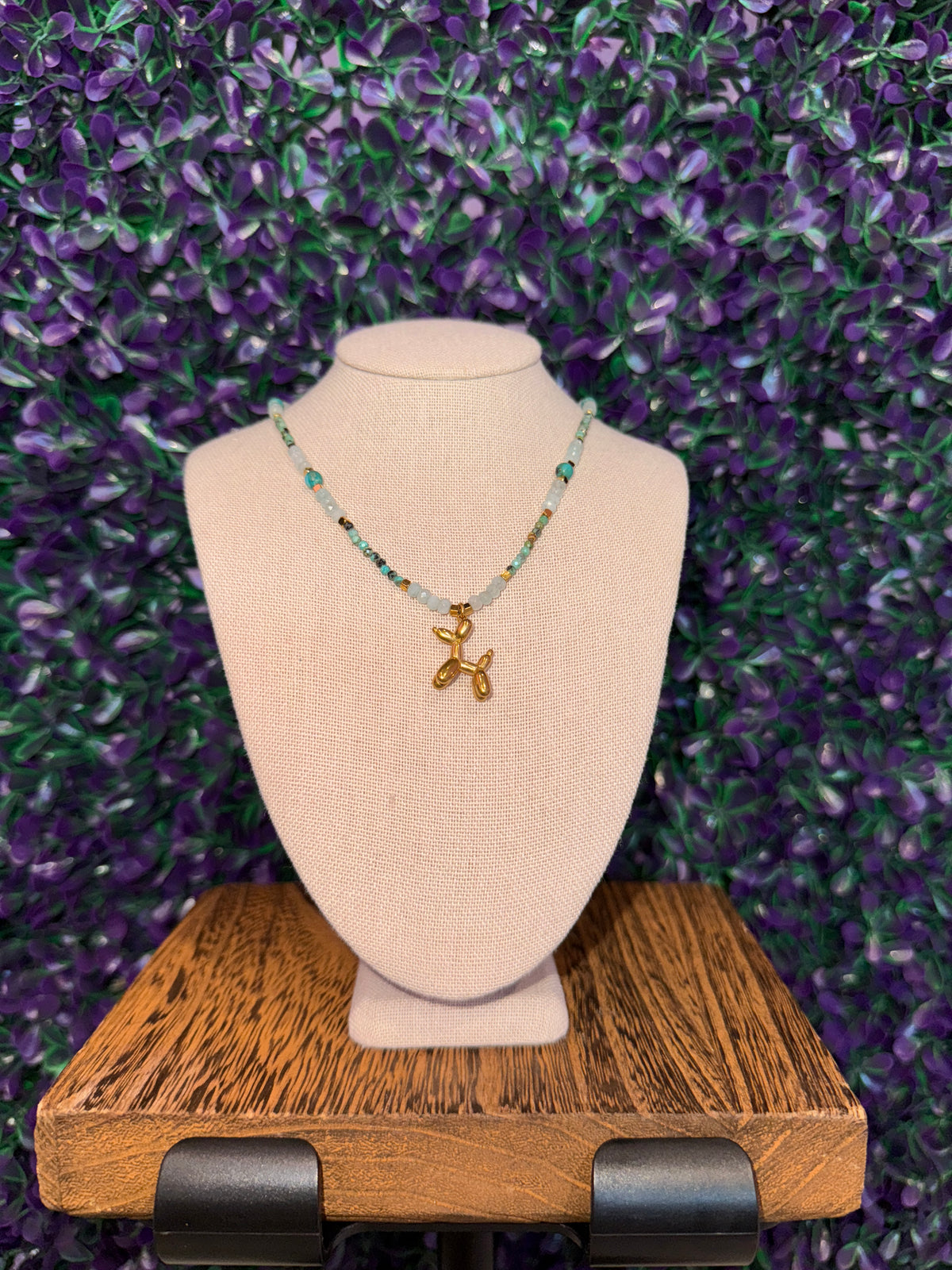 Balloon Dog Charm Necklace — product photo 2. A gold-tone balloon dog charm on an aqua faceted bead chain with gold-tone spacers.
