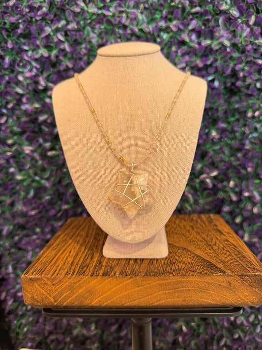 Cream and Peach Star Necklace — product photo 2. A cream, white, and peach star pendant framed in silver-tone wire, paired with a pale faceted bead chain.