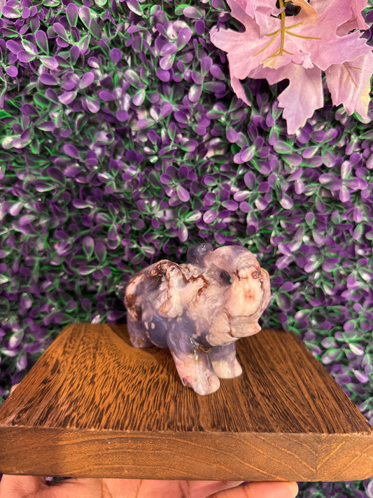 Front three-quarter view of the same elephant showing white floral inclusions.