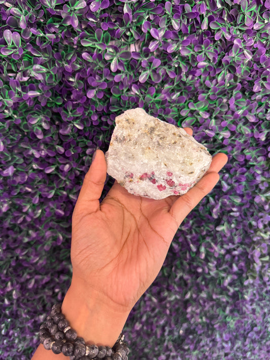 Hand-held view of the same rough specimen with mica shimmer.