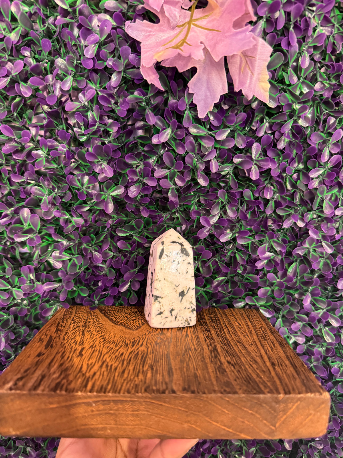 Black-Spotted Cream Stone Tower — product photo 2. A polished cream-colored stone tower with black spots and a pointed, faceted top.