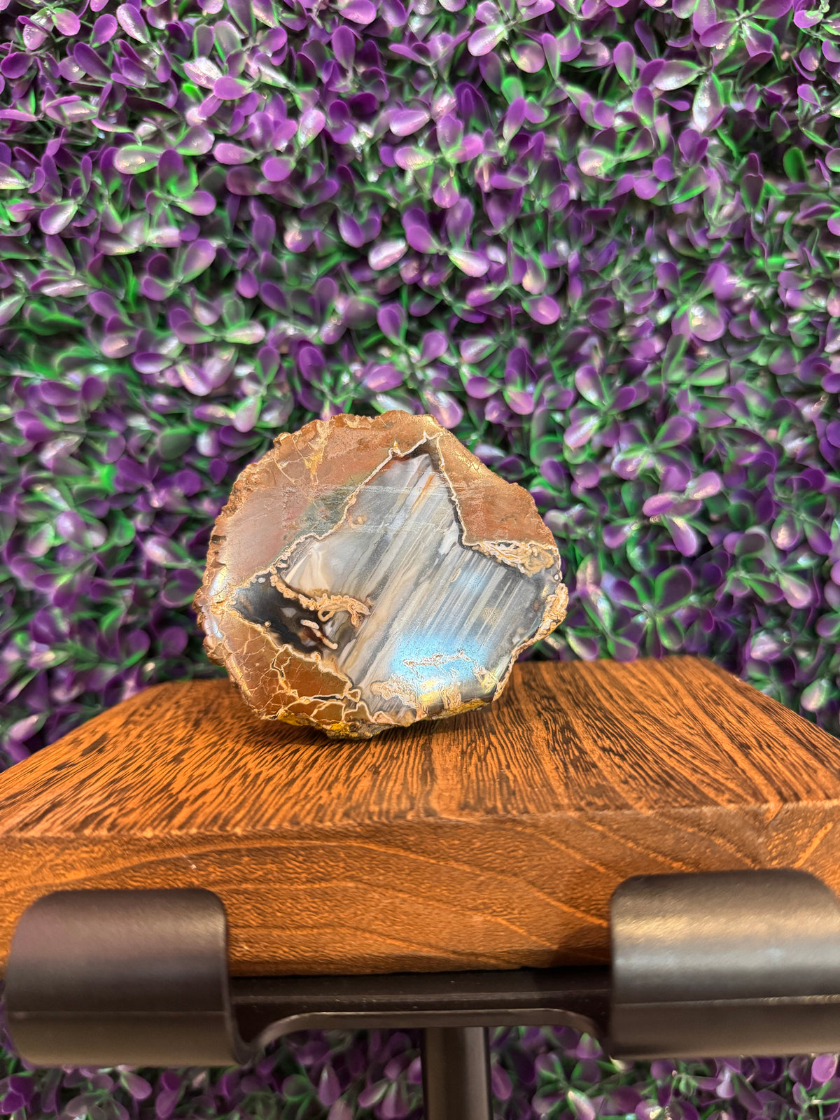 Blue-Gray Banded Geode — product photo 1. A geode with a polished blue-gray banded face and a contrasting rough tan outer rind.