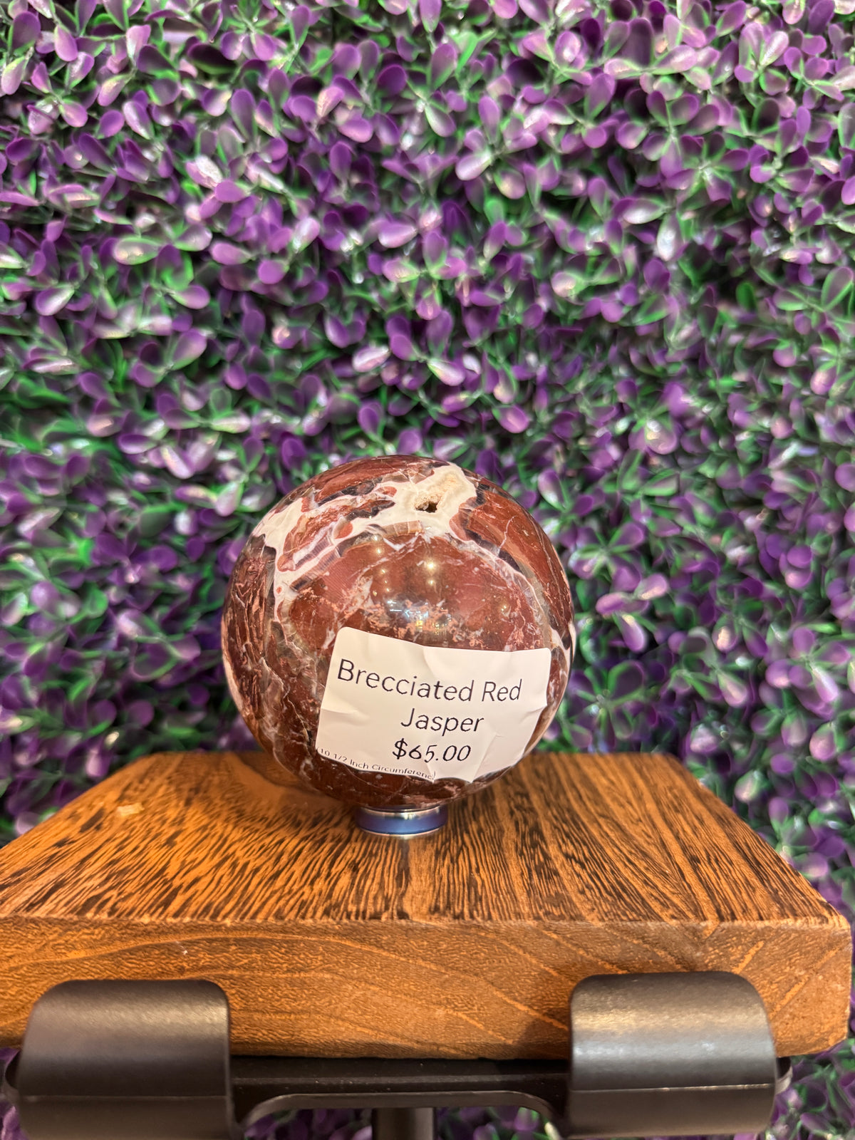 Brecciated red jasper sphere with a printed tag reading Brecciated Red Jasper $65.00.