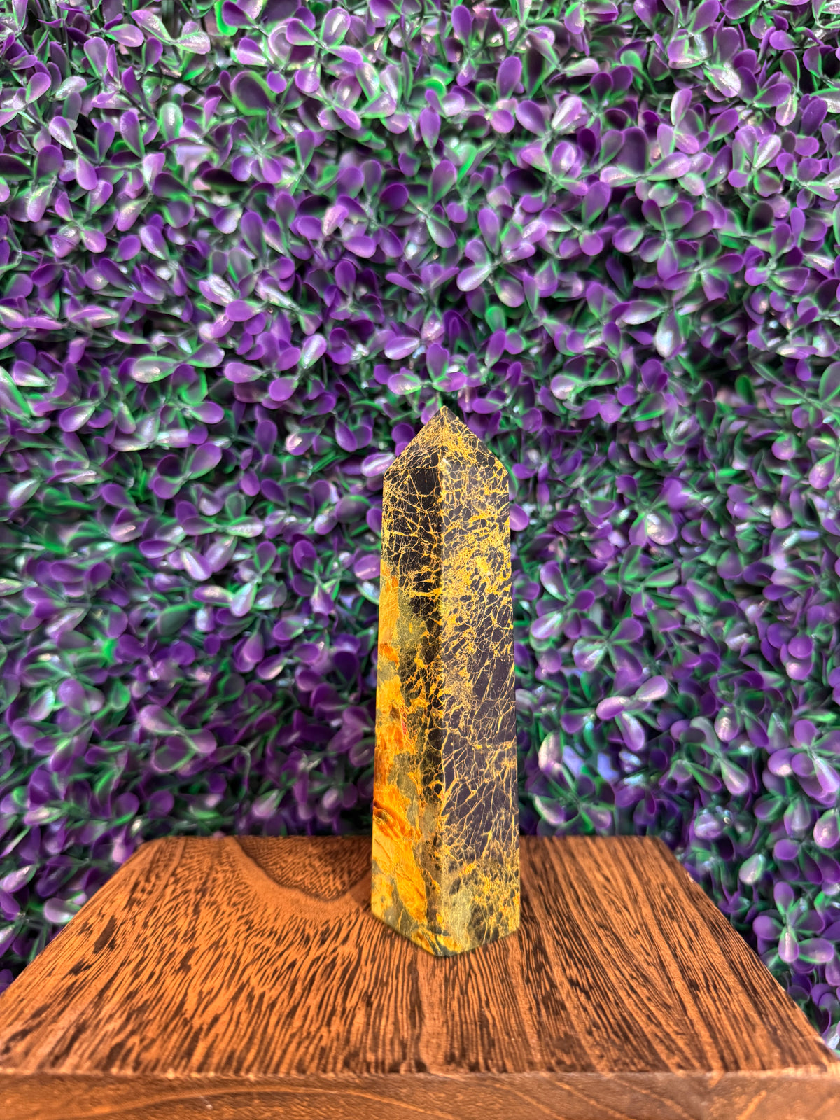 Third angle of the bumblebee jasper tower against purple foliage.