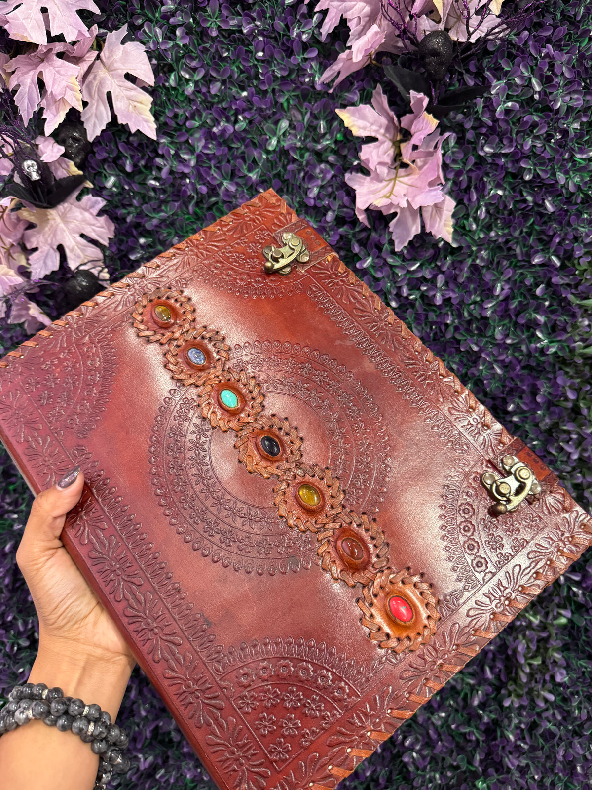 Chakra Mandala Cabochon Journal — product photo 3. A red-brown leather-style journal with an embossed mandala, seven colorful cabochons, and two antique brass-tone clasps.