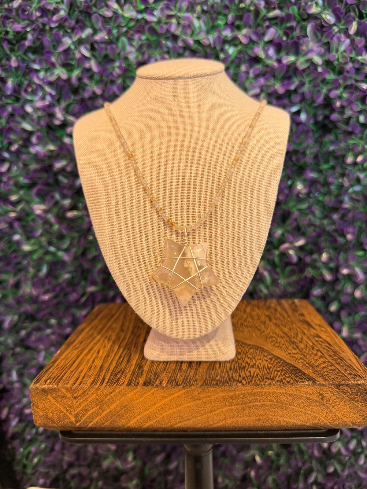 Cream and Peach Star Necklace — product photo 2. A cream, white, and peach star pendant framed in silver-tone wire, paired with a pale faceted bead chain.