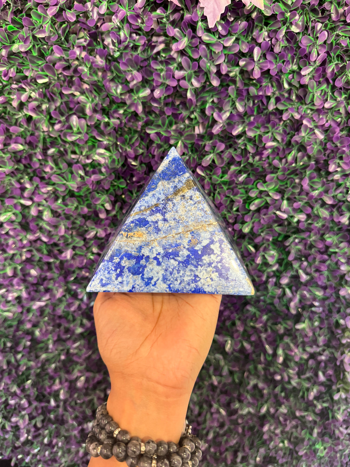 Second angle of the same lapis pyramid highlighting calcite veins.