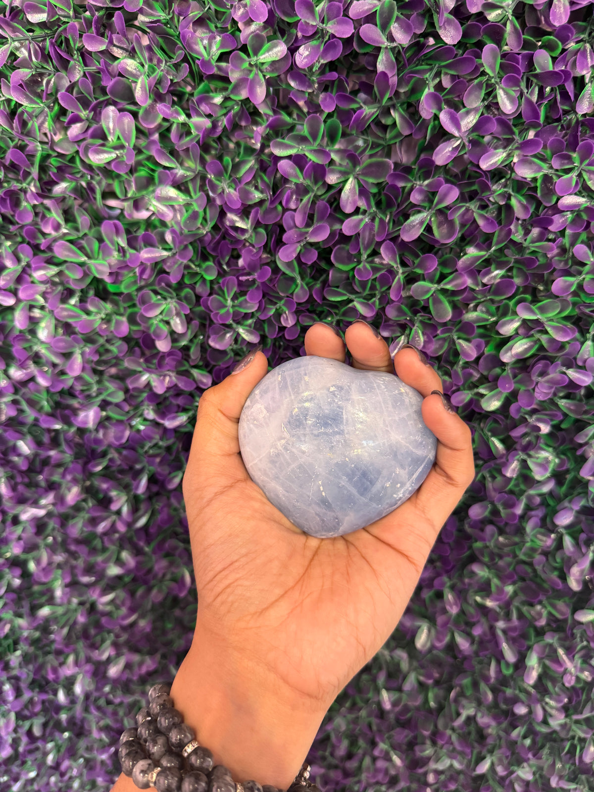 Pale Blue Heart Palm Stone — product photo 1. A smooth, puffy heart-shaped palm stone in soft pale blue, with cloudy white markings.