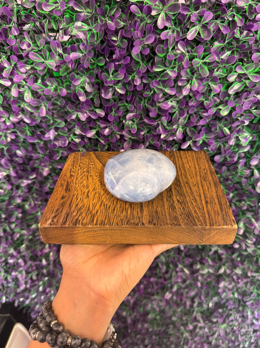 Pale Blue Heart Palm Stone — product photo 2. A smooth, puffy heart-shaped palm stone in soft pale blue, with cloudy white markings.
