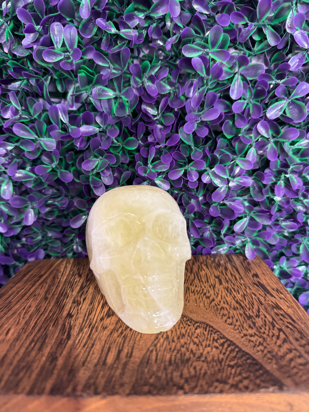 Pale Yellow-Green Skull Carving — product photo 1. A smooth, polished skull carving in translucent pale yellow-green tones, with softly carved features.