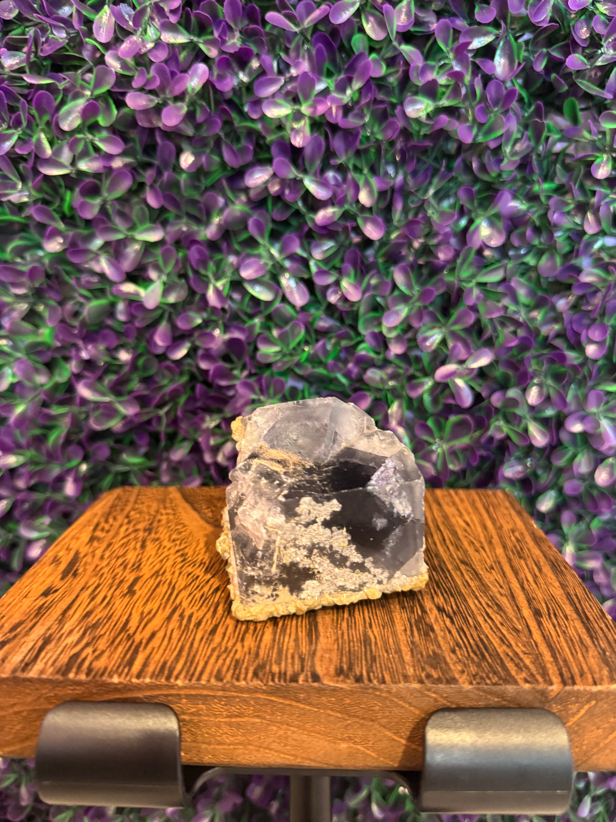 Purple Raw Mineral Specimen — product photo 1. A raw mineral specimen showing clear-to-purple areas, deeper purple zoning, and a pale matrix base.