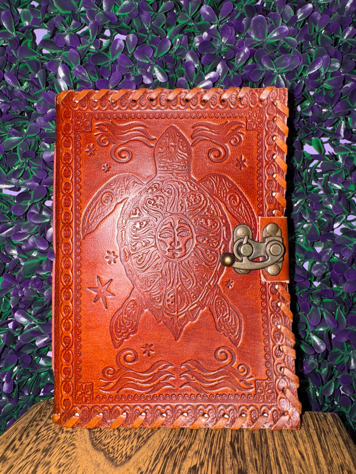 Front cover of the sea turtle journal showing the sun face on the turtle's shell.