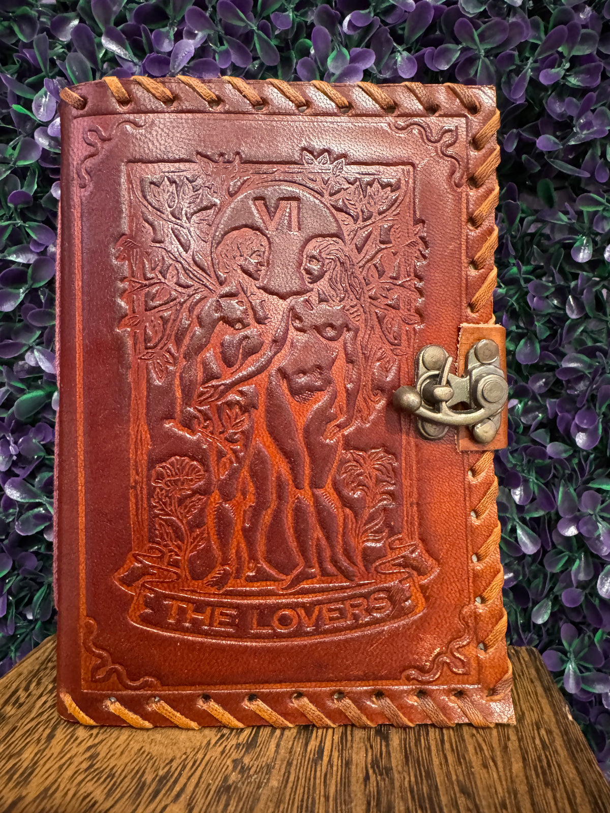 Red-brown embossed journal with The Lovers tarot card design and a brass-tone clasp.