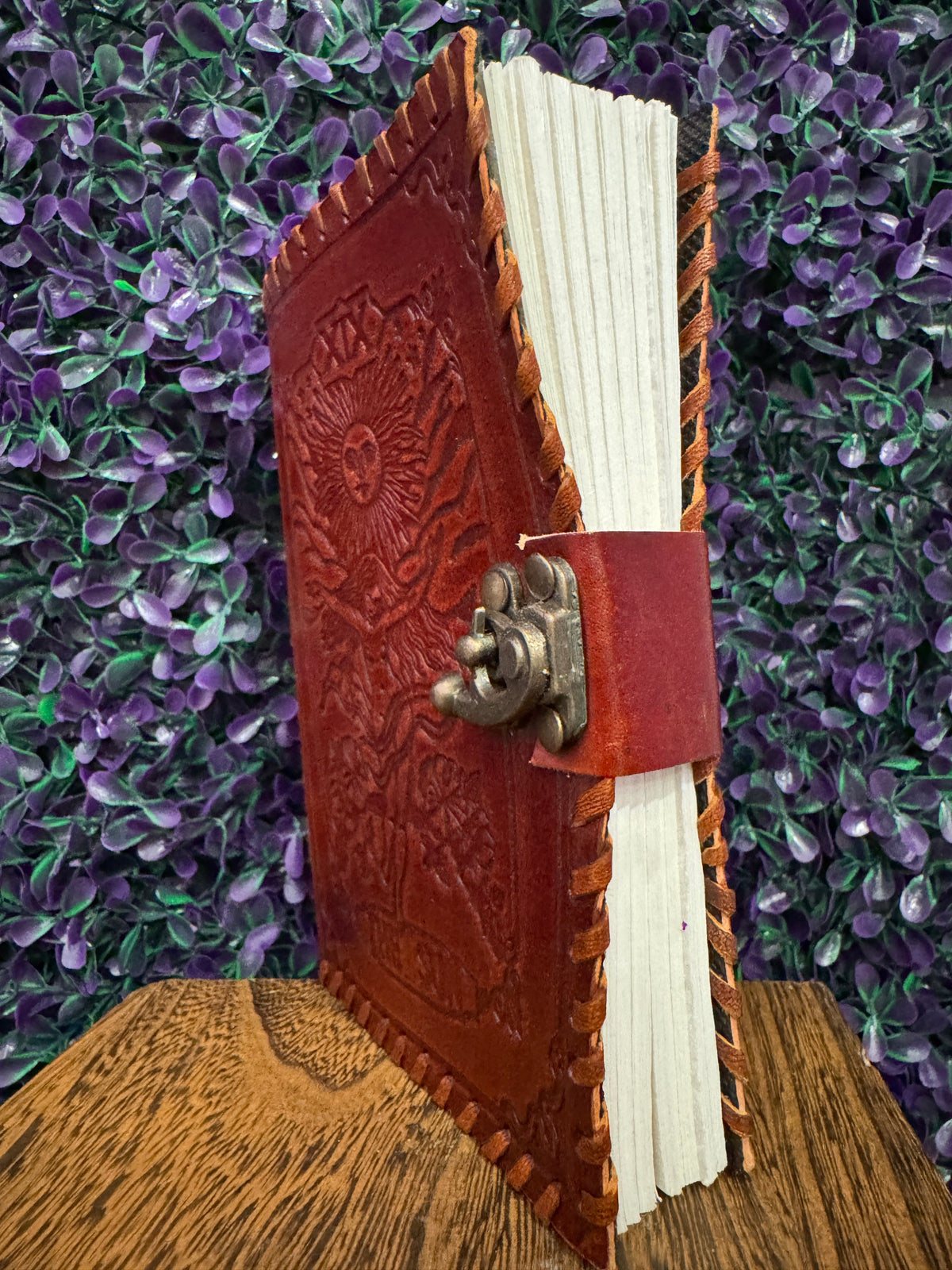 Side view of The Sun tarot journal showing the clasp and thick page block.
