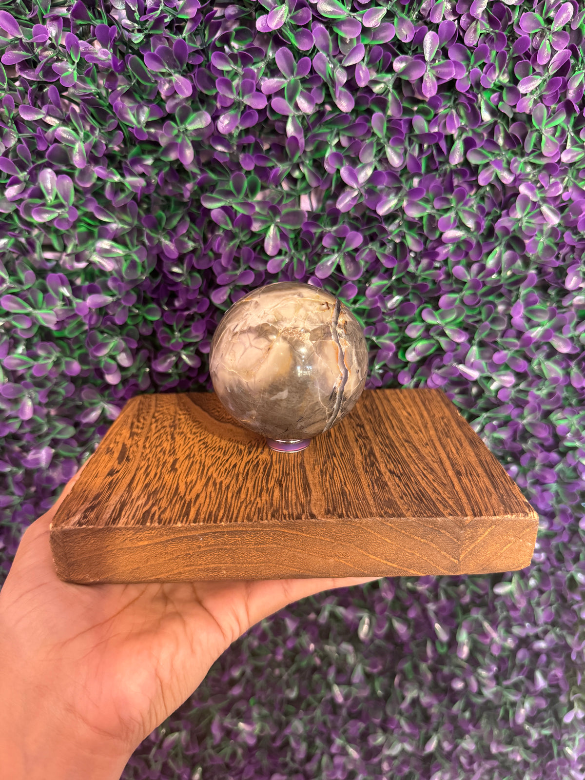 Second angle of the same volcano agate sphere on its stand.
