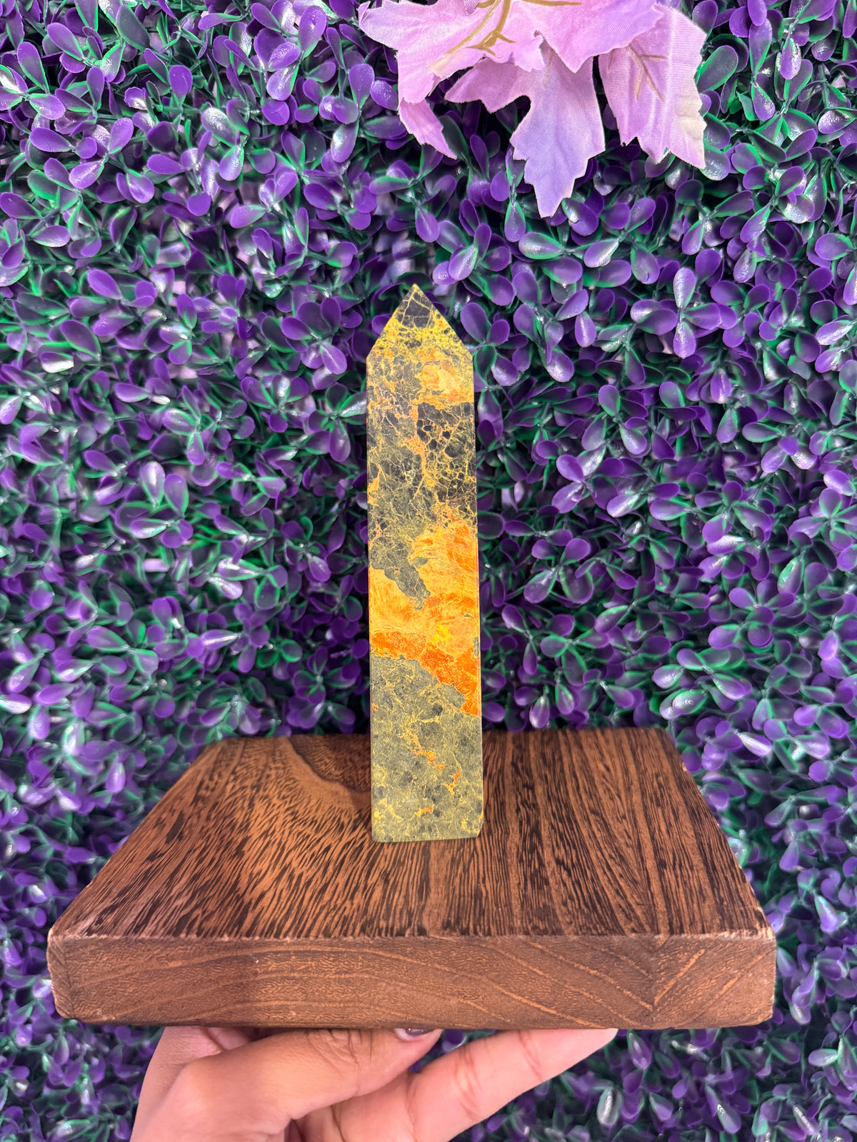 Yellow-Green Stone Tower — product photo 1. A slim, pointed stone tower with yellow-green coloring and contrasting orange-yellow bands.