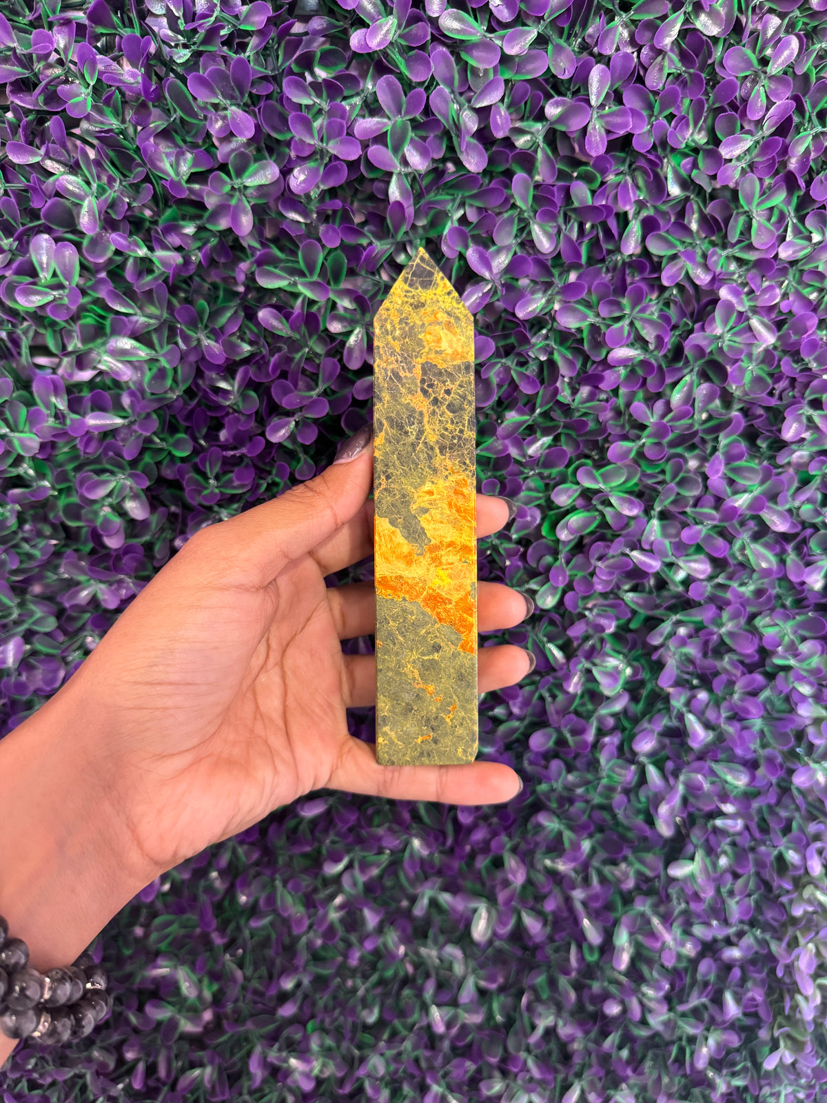 Yellow-Green Stone Tower — product photo 3. A slim, pointed stone tower with yellow-green coloring and contrasting orange-yellow bands.